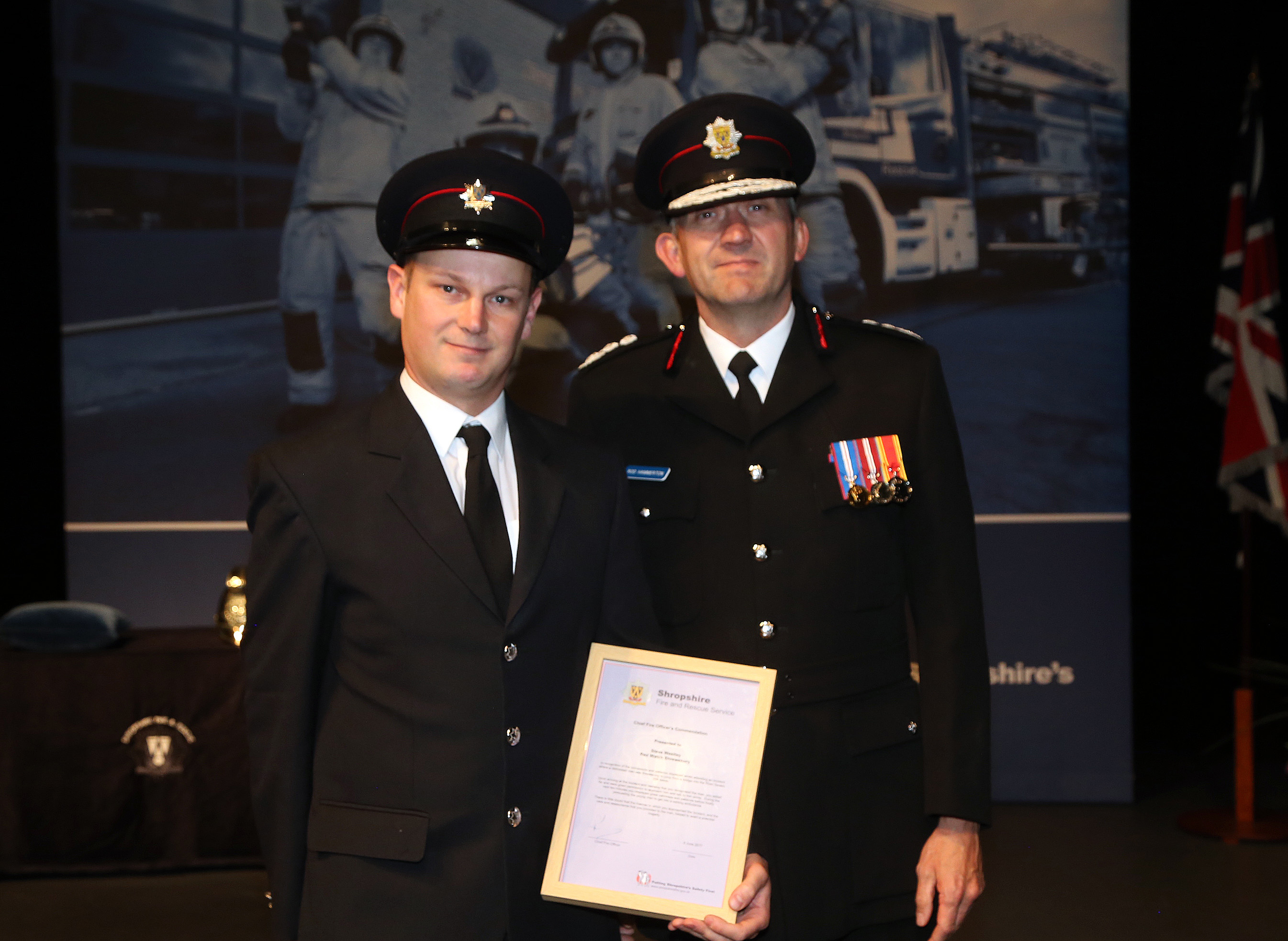Shrewsbury firefighter Steve Westley receives the Chief Fire Officer’s Commendation from Rod Hammerton for his “cool-headed” actions in talking down a young man who was preparing to jump from a bridge into the River Severn.