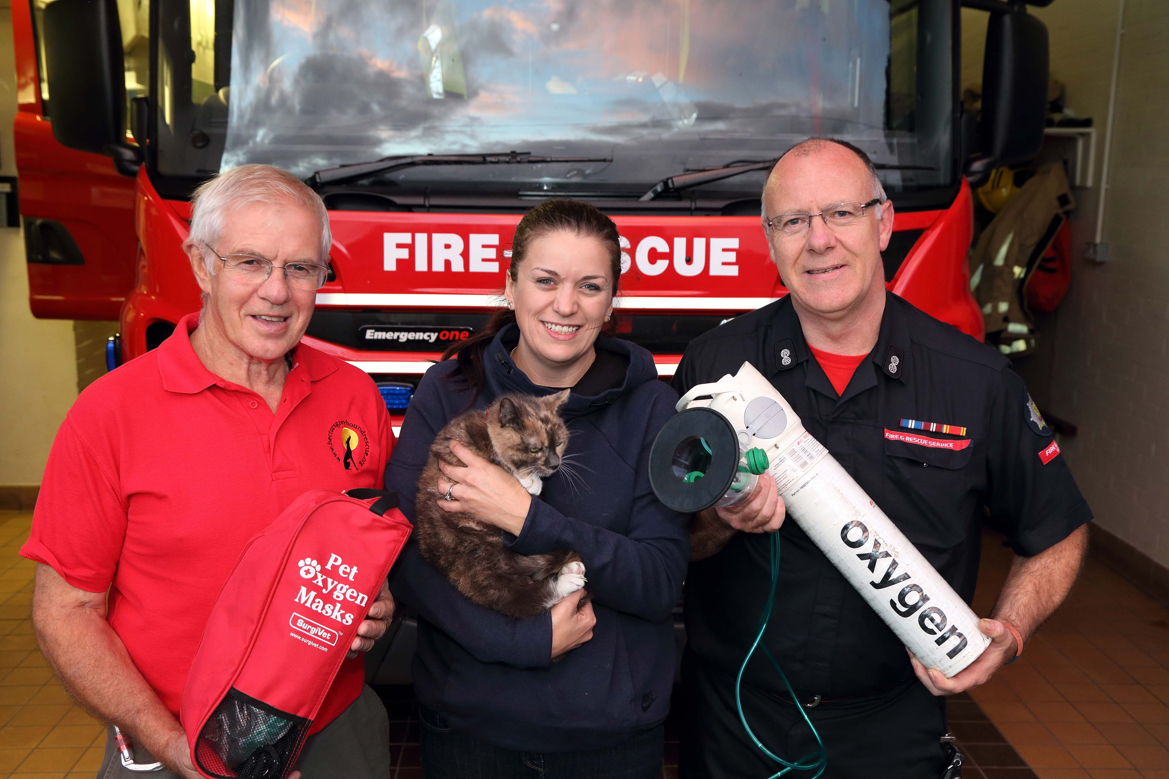 Fundraiser Fred Brown, pet owner Shelley Hall and Watch Manager Steve Moorhouse Harriet the cat at Ellesmere Fire Station. Harriet is the first animal in Shropshire to be revived with the new pet oxygen mask after a house fire