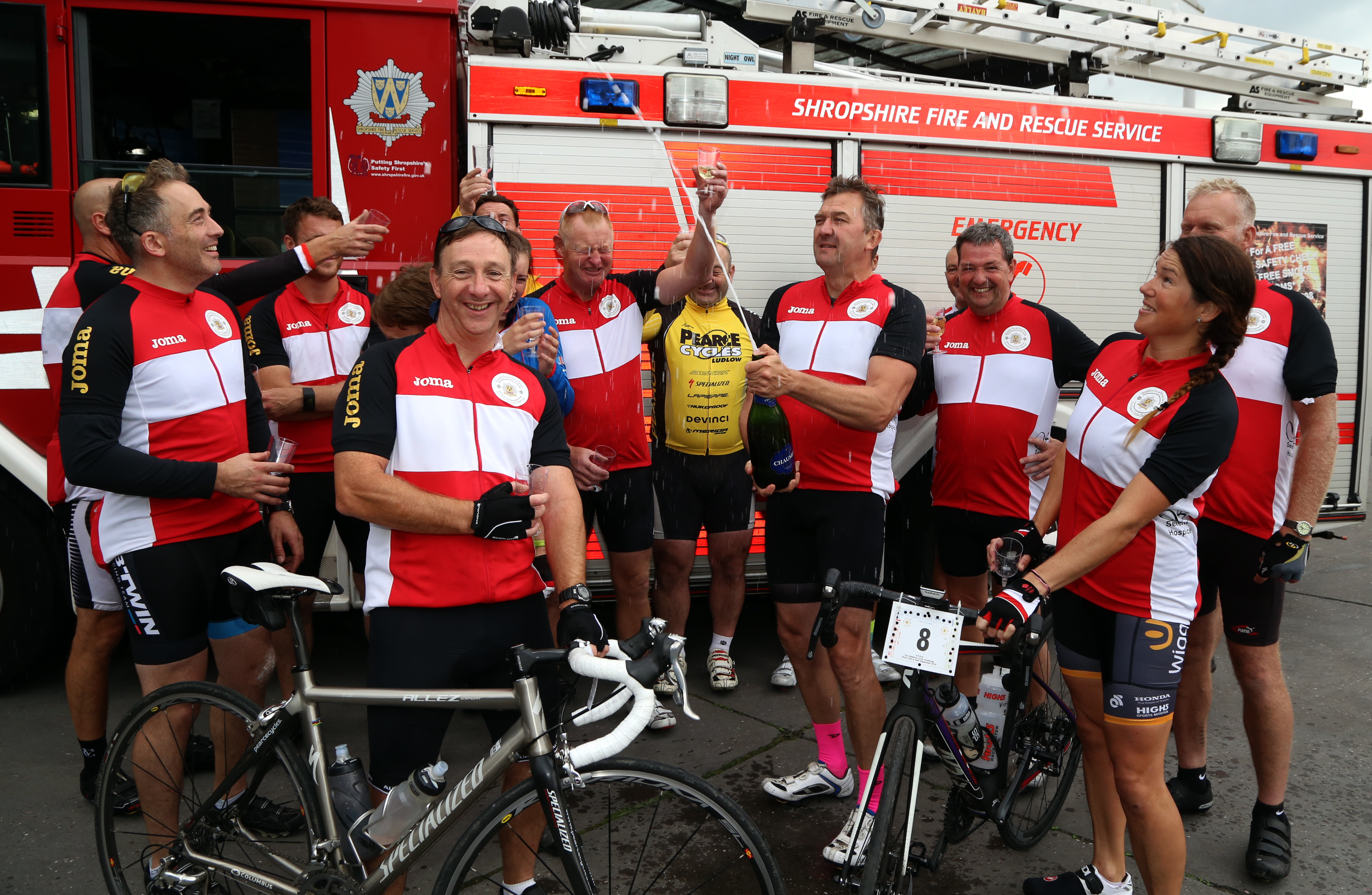 Champagne corks popped at the end of a marathon three day charity cycle ride in aid of The Severn Hospice and the Fire Fighters Charity by members of Shropshire Fire and Rescue Service.