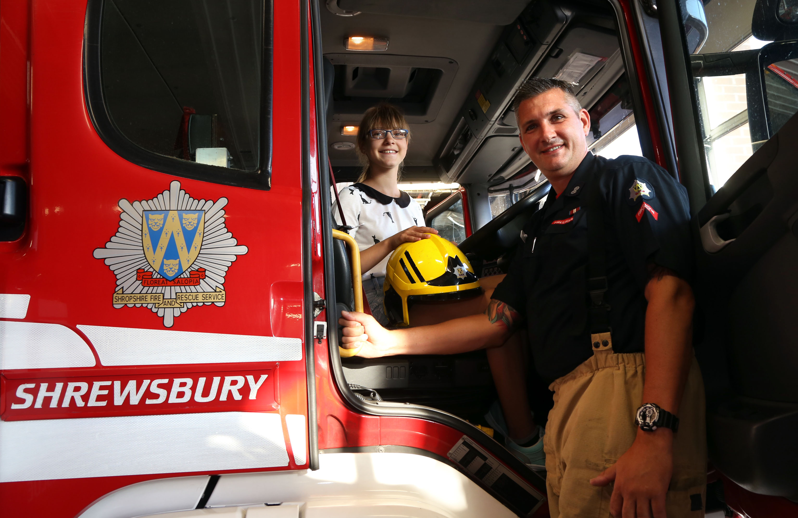 Blue Watch Shrewsbury Watch Manager Paul Gray with Vlada Shatilo (12) as she enjoys the view from the driver's seat 