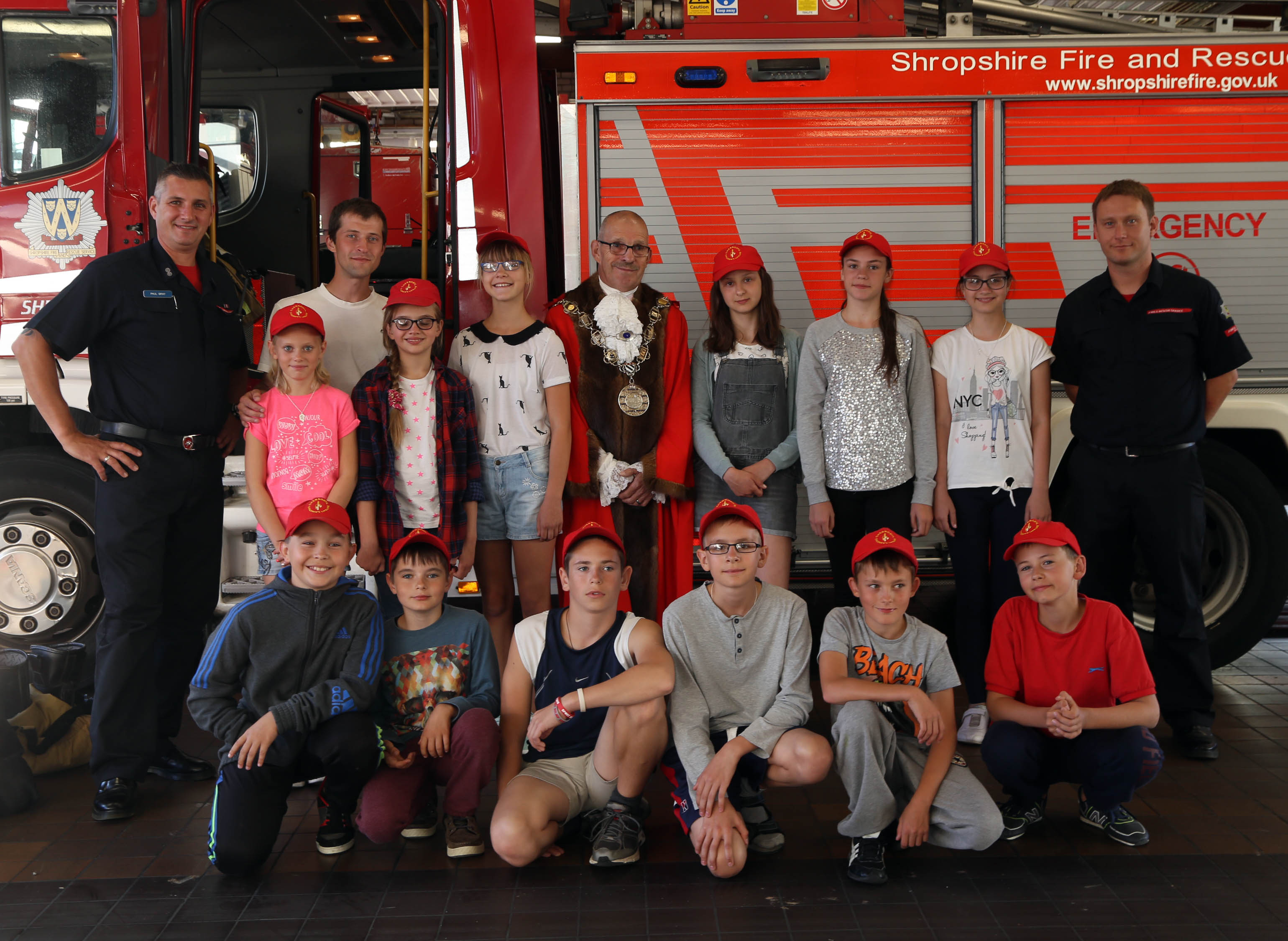 A formal line up in front of a Shropshire Fire and Rescue Service appliance as a memory of the trip to Shrewsbury Fire Station by children from Chernobyl