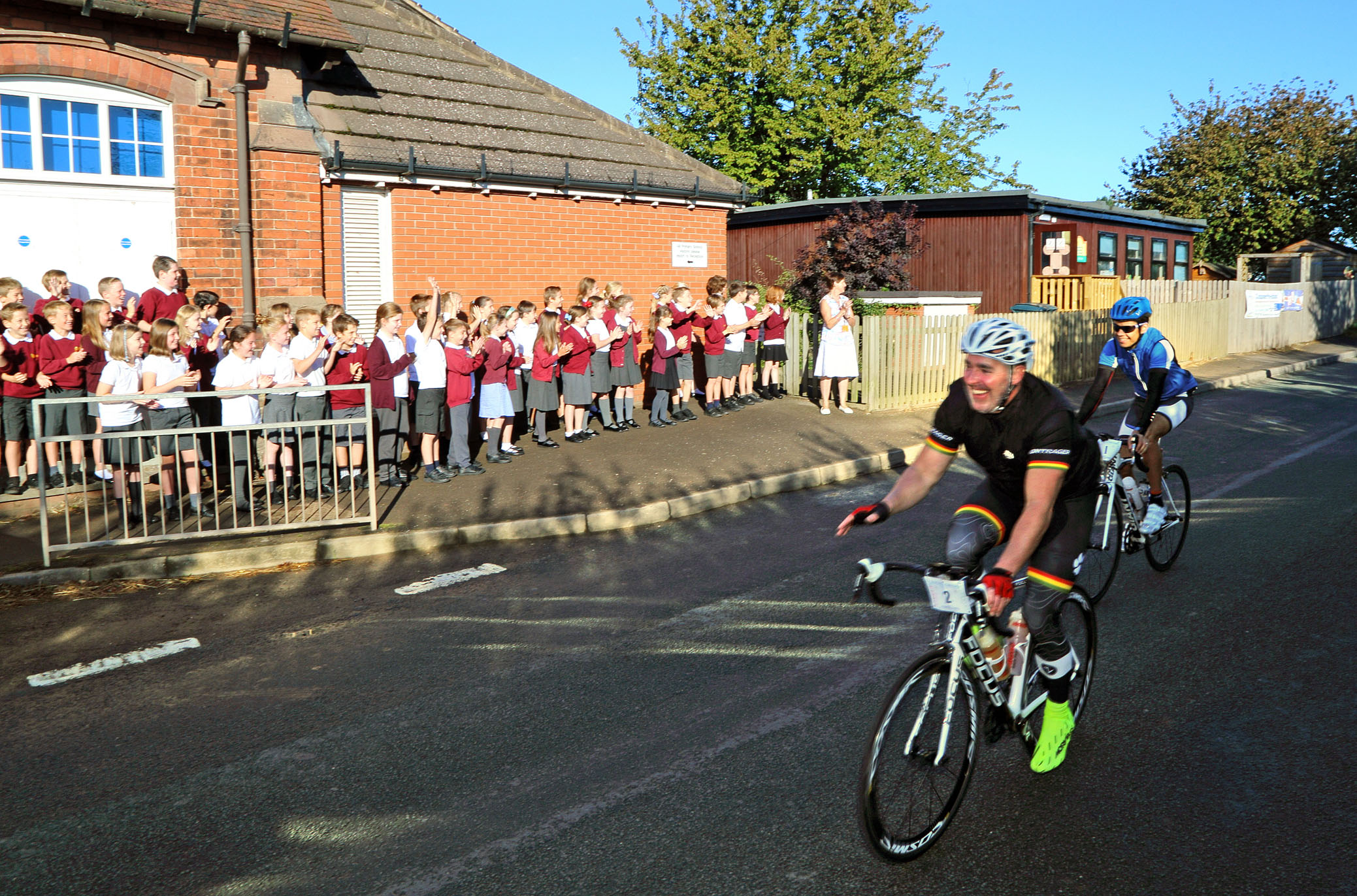 Primary schoolchildren from Condover School cheer cyclists en route