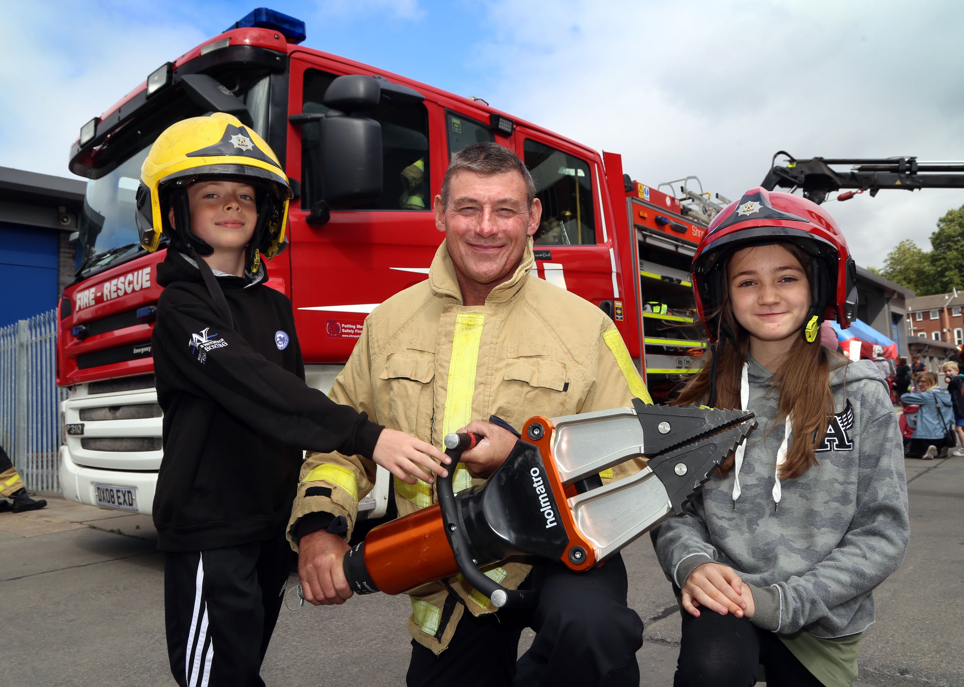 Firefighter Chris Davey shows Joe Sheridan (9) and Tabitha Bridgman (12) the special cutters used to rescue people from road traffic collisions.