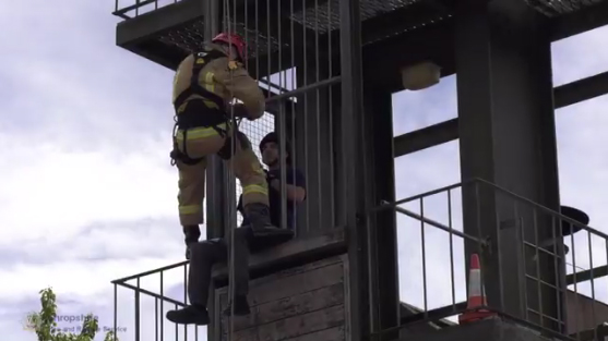 Firefighter Matt Stenton rescues a colleague from a tower in a demonstration or rope skills at Telford fire station's open day