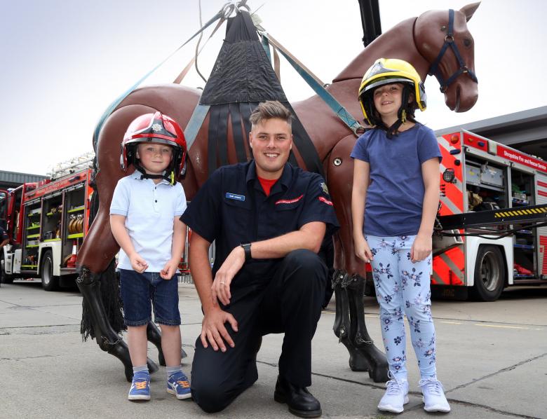 At Shrewsbury Fire Station's annual 2018 open day is firefighter Sam Dawes with Benjamin (6) and Hannah Bradley (10) with Bullseye, a replica horse used to train firefighters in animal rescues. 