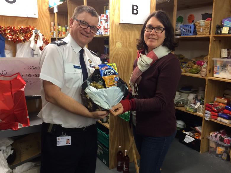 Deputy Chief Fire Officer Andy Johnson and Shrewsbury Food Plus Project Leader Karen Williams with one of the many food parcels being distributed to people in need today.