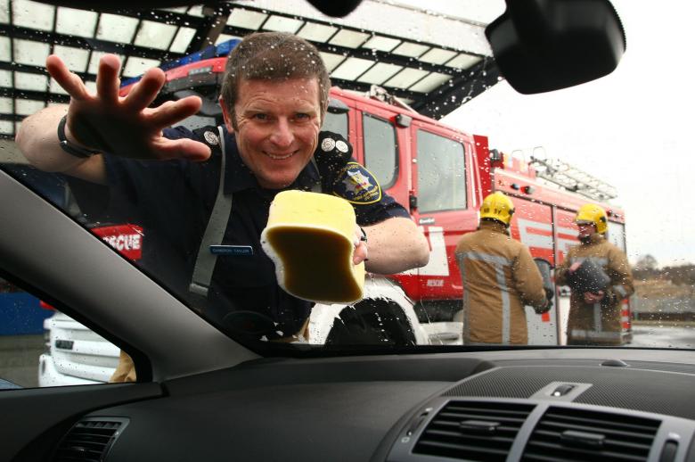 Firefighter Cameron Taylor at a previous charity car wash